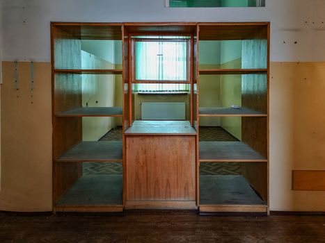 Old wooden bookshelf at reception in old abandoned hospital