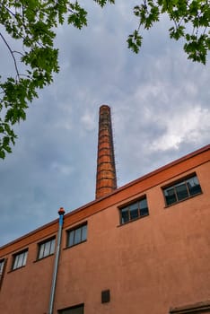 Upward view to brick chimney at sunny day in Wroclaw City