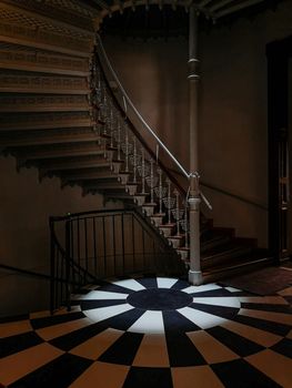 Old spiral staircase with ornaments in tenement house 