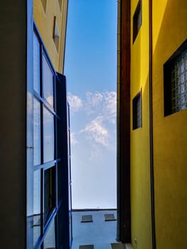 Upward look to narrow alley between tall city buildings