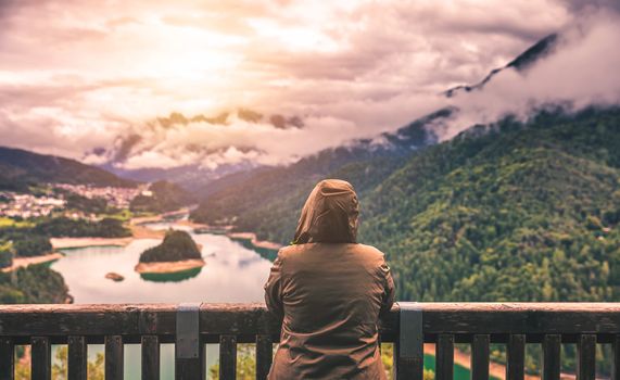 Traveler relaxing meditation with serene view mountains and lake landscape. Travel Lifestyle hiking concept summer vacations outdoor.
