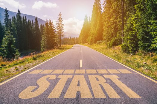 Start written on mountain road, concept of start straight for business, vision for a new beginning with a sign start