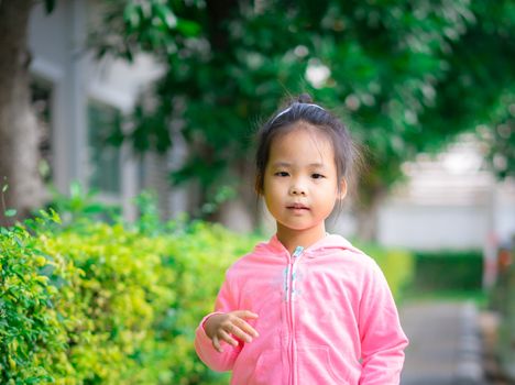 little girl wear jacket in the park