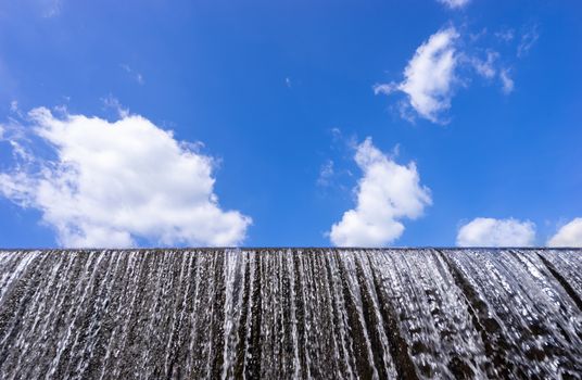 water flow at weir and blue sky