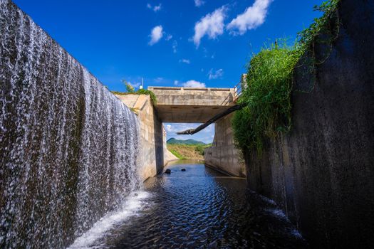 spillway of weir and the mountain with beautiful blue sky