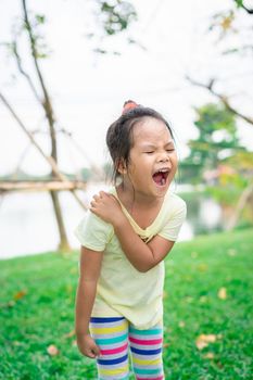 little girl with shoulder pain or stiffness