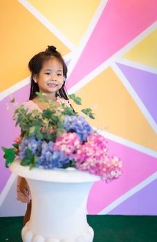 Portrait of little asian girl with vintage wall indoor