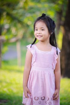 portrait of cute little girl standing in the park