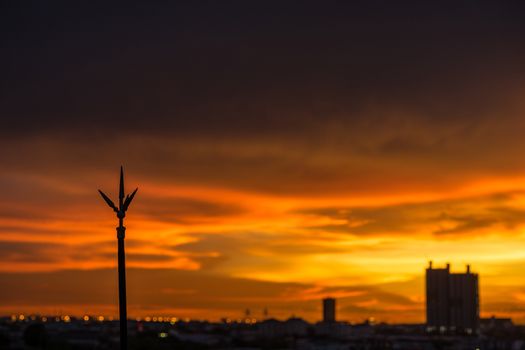 Lightning rod on the rooftop of condominium with colorful sky