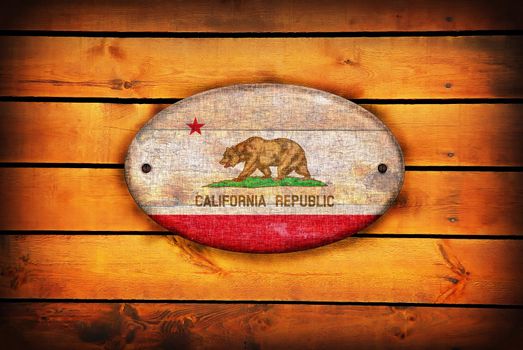 A California flag on brown wooden planks.