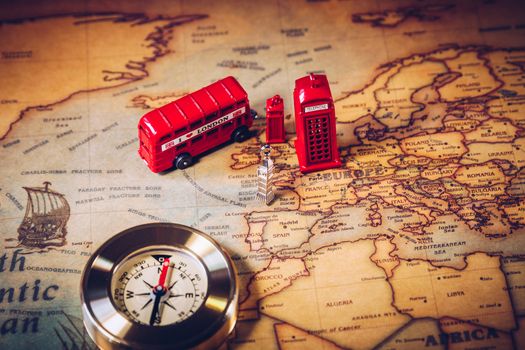 London map with Big Ben, double decker bus in miniature and compass, travel concept. England, UK.