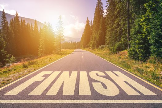 Asphalt road with finish line message. 