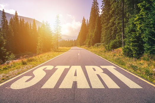 Start written on mountain road, concept of start straight for business, vision for a new beginning with a sign start