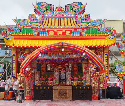 KAOHSIUNG, TAIWAN -- JULY 7, 2016: A Taiwan folk religion makeshift temple facade and altar is set in preparations for a religious festival.
