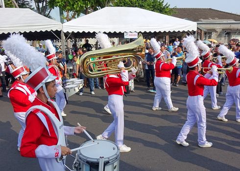 KAOHSIUNG, TAIWAN -- OCTOBER 1, 2017: A high school marching band joins a street parade at the opening of the 2017 Ecomobility Festival.