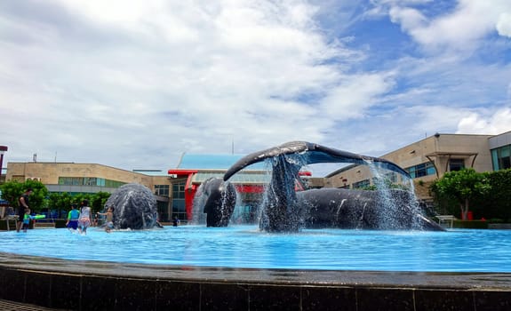 PINGTUNG, TAIWAN -- JULY 6 , 2017: The approach to the National Marine Biology Museum features a large fountain with realistic sculptures of whales.
