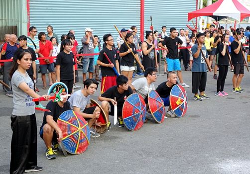 KAOHSIUNG, TAIWAN -- OCTOBER 15, 2016: Young people put on a martial art performance in front of the Yuan Di Temple during the yearly Wannian Folk Festival.