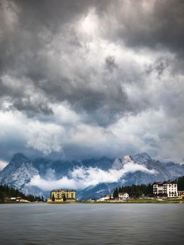 Misurina Lake in the Dolomites mountains in Italy near Auronzo di Cadore on a cloudy day, Sorapiss mountain in the background. South Tyrol, Dolomites, Italy.
