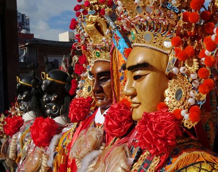 KAOHSIUNG, TAIWAN -- JUNE 10 , 2017: A set of large elaborate masks and costumes worn by dancers to represent deities popular in Taiwan's folk religion.