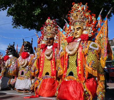 KAOHSIUNG, TAIWAN -- JUNE 10 , 2017: A set of large elaborate masks and costumes worn by dancers to represent deities popular in Taiwan's folk religion.