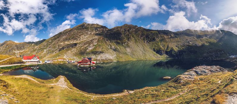 Balea glacier lake near the Transfagarasan road, panoramic view. Balea Lake, is a glacier lake situated at 2034m of altitude in the Fagaras Mountains, in central Romania, Sibiu County. 
