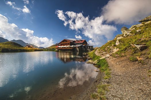 Balea glacier lake near the Transfagarasan road, panoramic view. Balea Lake, is a glacier lake situated at 2034m of altitude in the Fagaras Mountains, in central Romania, Sibiu County. 