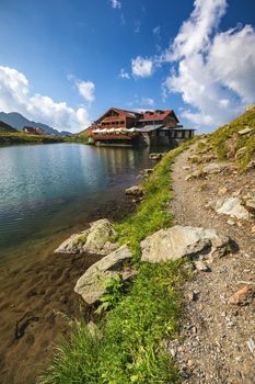 Balea glacier lake near the Transfagarasan road, panoramic view. Balea Lake, is a glacier lake situated at 2034m of altitude in the Fagaras Mountains, in central Romania, Sibiu County. 