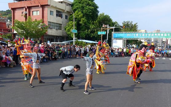 KAOHSIUNG, TAIWAN -- OCTOBER 1, 2017: Young people and traditional temple dancers perform at the opening of the 2017 Ecomobility Festival.