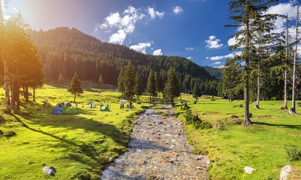 Camping Tent near mountain river in the summer. Adventures Camping tourism and tent, forest landscape near water outdoor. Concept Travel