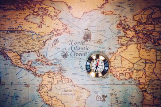 Golden Compass and the Map. Travel and Navigation Theme. Map used for background is in Public domain. Map source: Library of Congress. Country: Belgium Year: 1570. Author: Abraham Ortelius (1527-1598)