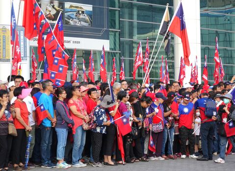 KAOHSIUNG, TAIWAN -- OCTOBER 10, 2019: People waving national flags gather to celebrate the national day of the Republic of China at a free, public event. 

