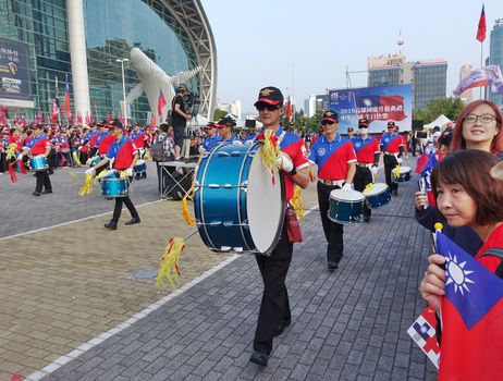 KAOHSIUNG, TAIWAN -- OCTOBER 10, 2019: A marching band dressed in national flag colors takes part in the national day celebrations at a free, public event. 
