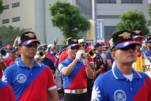 KAOHSIUNG, TAIWAN -- OCTOBER 10, 2019: A marching band dressed in national flag colors takes part in the national day celebrations at a free, public event. 
