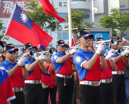 KAOHSIUNG, TAIWAN -- OCTOBER 10, 2019: A marching band dressed in national flag colors takes part in the national day celebrations at a free, public event. 
