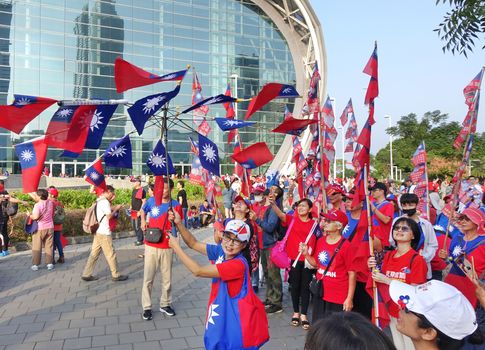 KAOHSIUNG, TAIWAN -- OCTOBER 10, 2019: An excited crowd waves national flags during the national day celebrations at a free, public event.