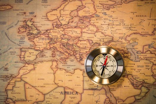 Travel concept background, vintage compas and old earth map 