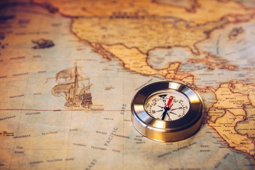 Travel concept background, vintage compas and old earth map 