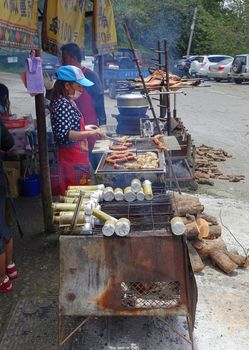 KAOHSIUNG, TAIWAN -- JULY 24, 2016: A traditional market in the aboriginal mountain village of Baoshan offers roast pig, sausages, rice cooked in bamboo and other foods.