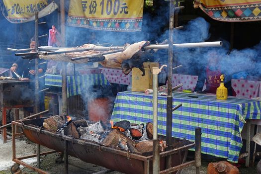 KAOHSIUNG, TAIWAN -- JULY 24, 2016: A traditional market in the aboriginal mountain village of Baoshan offers roast pig, sausages, rice cooked in bamboo and other foods.