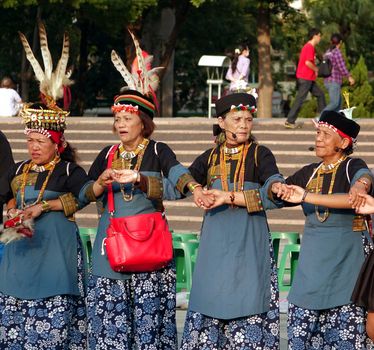 KAOHSIUNG, TAIWAN -- NOVEMBER 8, 2014: Native women of Taiwan in their tribal costumes perform a traditional wedding dance.