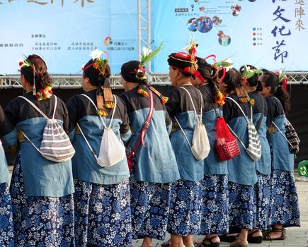 KAOHSIUNG, TAIWAN -- NOVEMBER 8, 2014: Native women of Taiwan in their tribal costumes perform a traditional wedding dance.