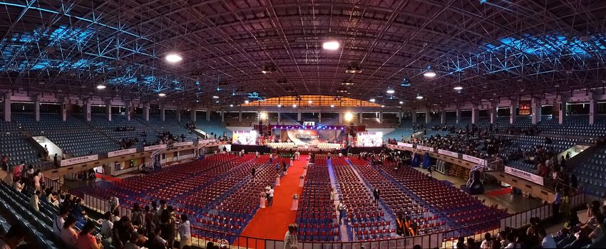 TAINAN, TAIWAN -- JUNE 2, 2018: Graduates enter a large auditorium for the annual graduation ceremony of NCKU university.