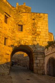 Sunrise view of the Arco del Cristo arch and gate, in Caceres, Extremadura, Spain