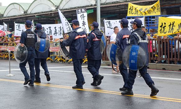 KAOHSIUNG, TAIWAN -- JULY 31 , 2017: Police in riot gear at the opening of a controversial new road. The construction had led to forced evictions of residents.