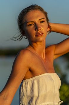 A gorgeous blonde model enjoys a summers day outdoors in a park