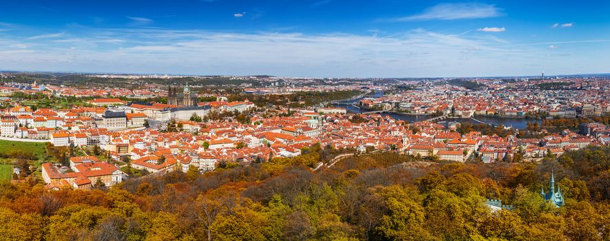 Autumn panoramic aerial view of houses and roofs of Prague old city town including Prague Castle and Charles bridge. Czech Republic