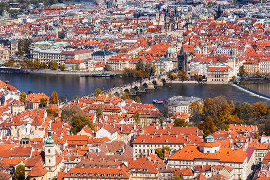 Autumn aerial view of houses and roofs of Prague old city town including Charles bridge. Czech Republic