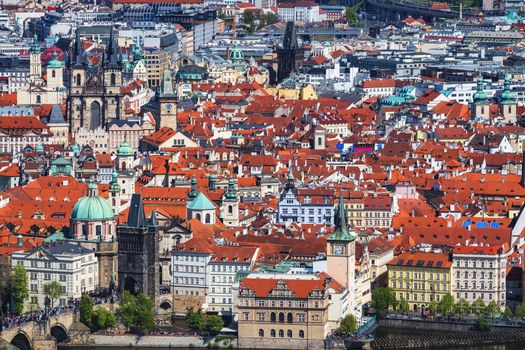 erial view of old Red Tiles roofs in the city Prague, Czech Republic, Europe. Beautiful day with blue sky with clouds in the town.