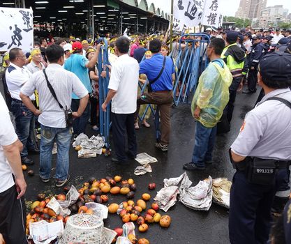 KAOHSIUNG, TAIWAN -- JULY 31 , 2017: Angry protesters dump rotten fruit to demonstrate against the opening of a controversial new road. 
