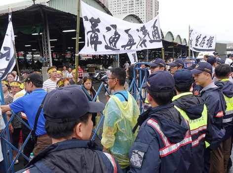 KAOHSIUNG, TAIWAN -- JULY 31 , 2017: Police block protesters from interfering with the opening of a controversial new road. 